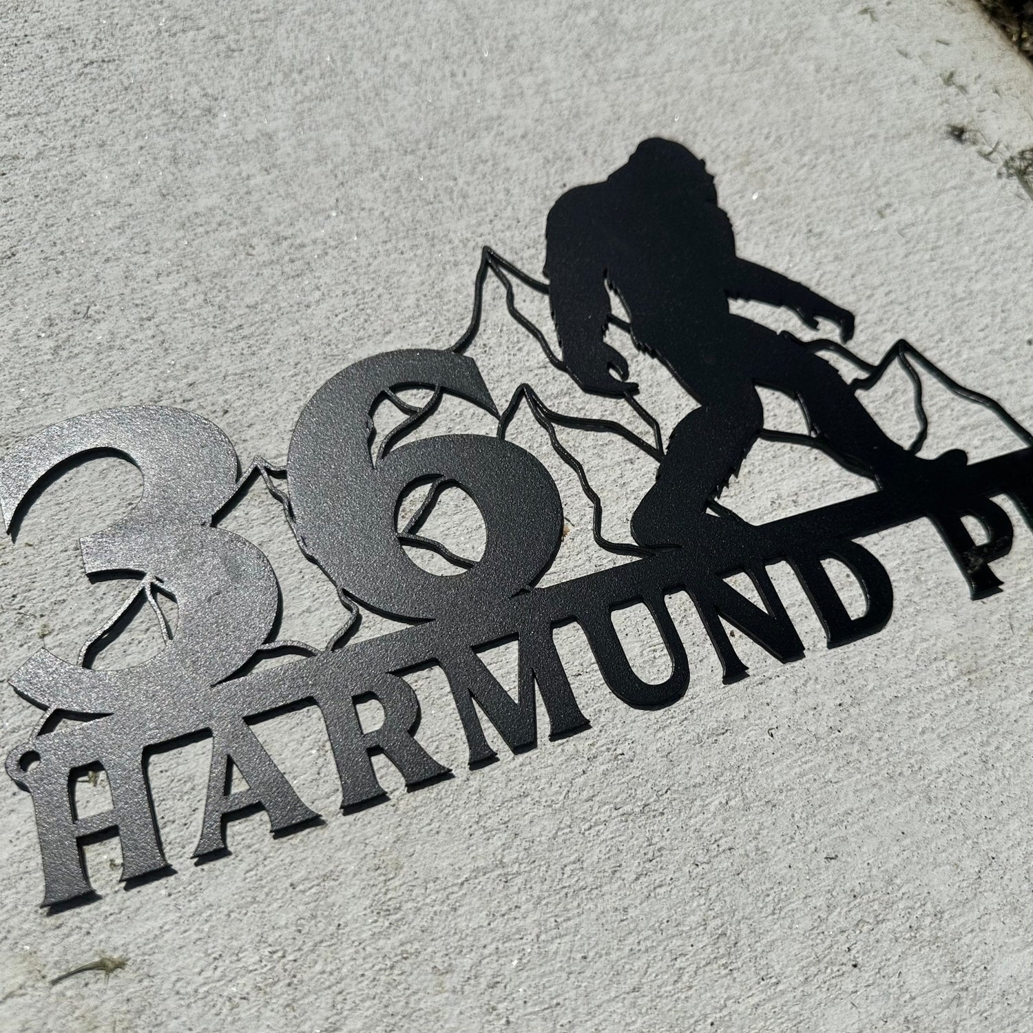Personalized Metal Address Sign - Sasquatch themed address sign laying on the ground