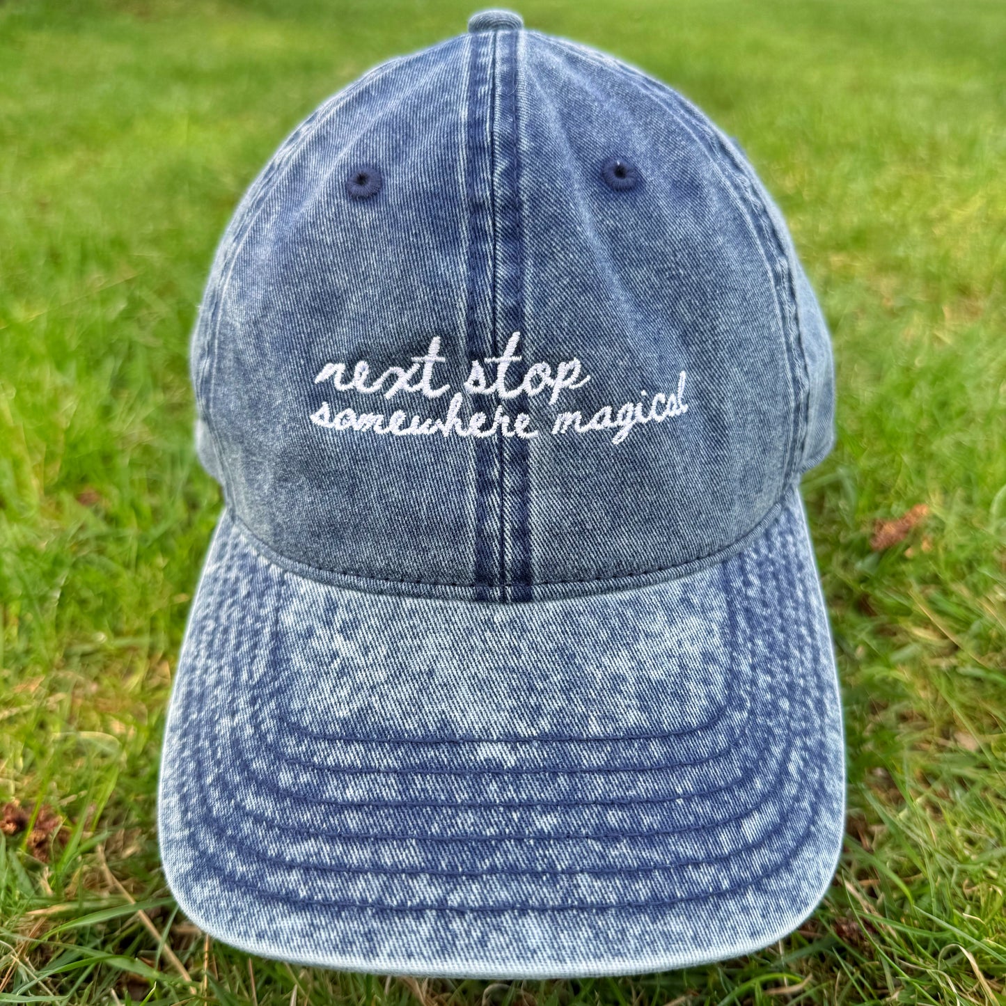 "Next stop somewhere magical" Funny Travel Hat for Theme park lovers-on grass