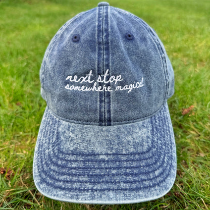 "Next stop somewhere magical" Funny Travel Hat for Theme park lovers-on grass
