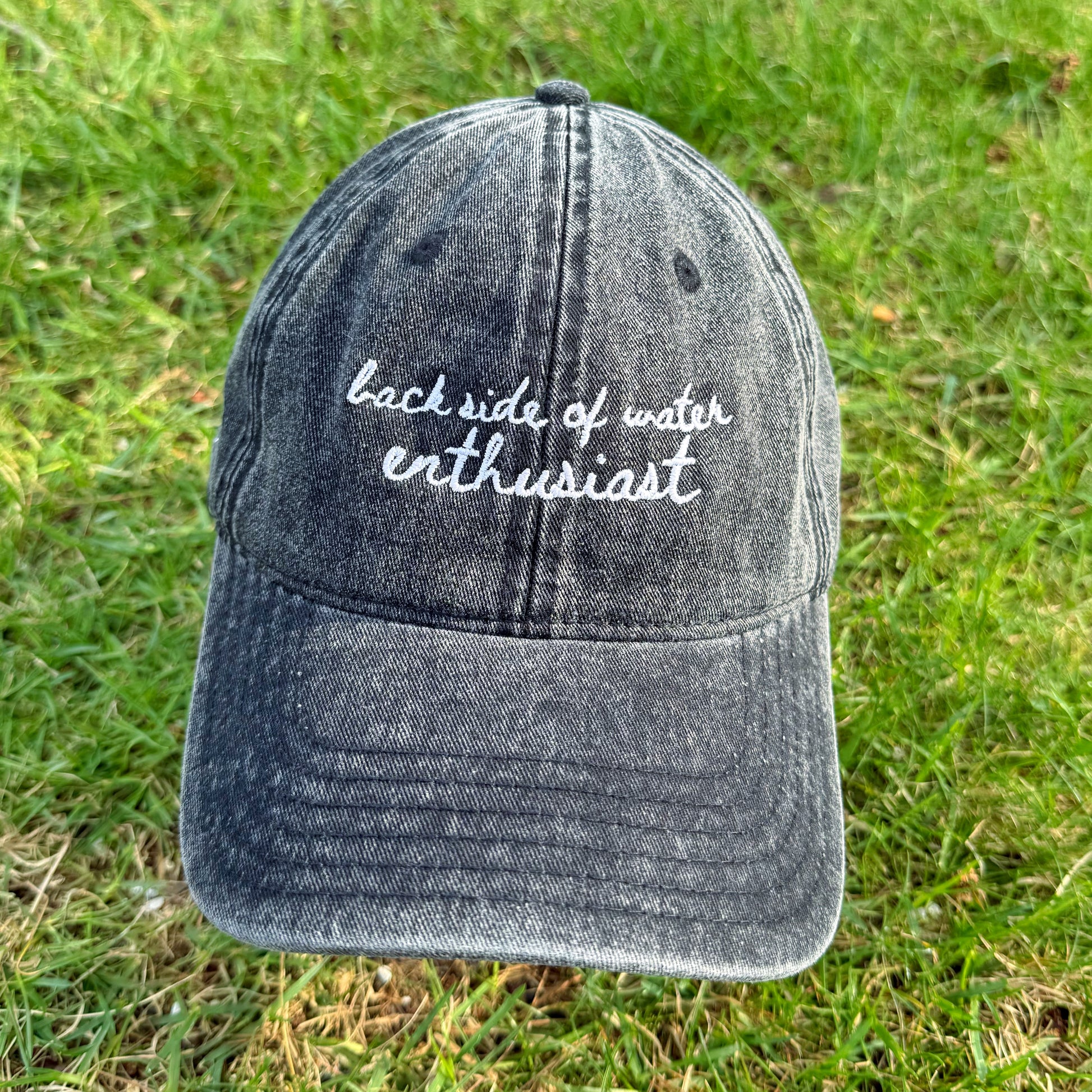 "Back side of water enthusiast" Funny Travel Hat for Theme Park Lovers - in grass