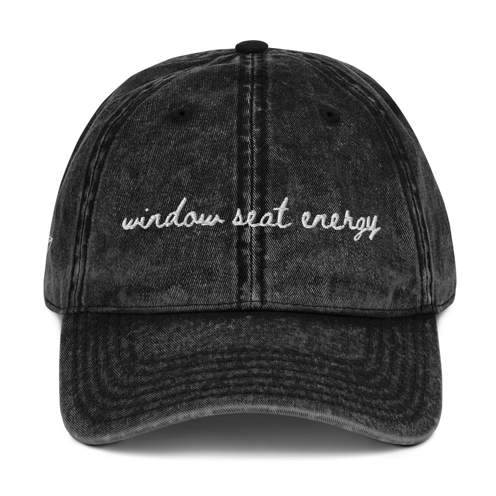 Vintage wash black travel hat with the words "window seat energy" embroidered on it